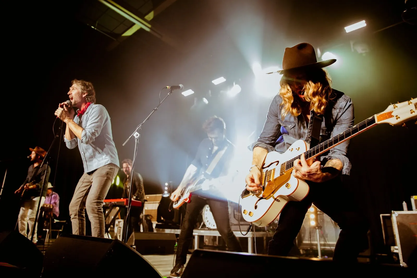 Jamey performing live with Green River Ordinance, hollow-body guitar in hand.
