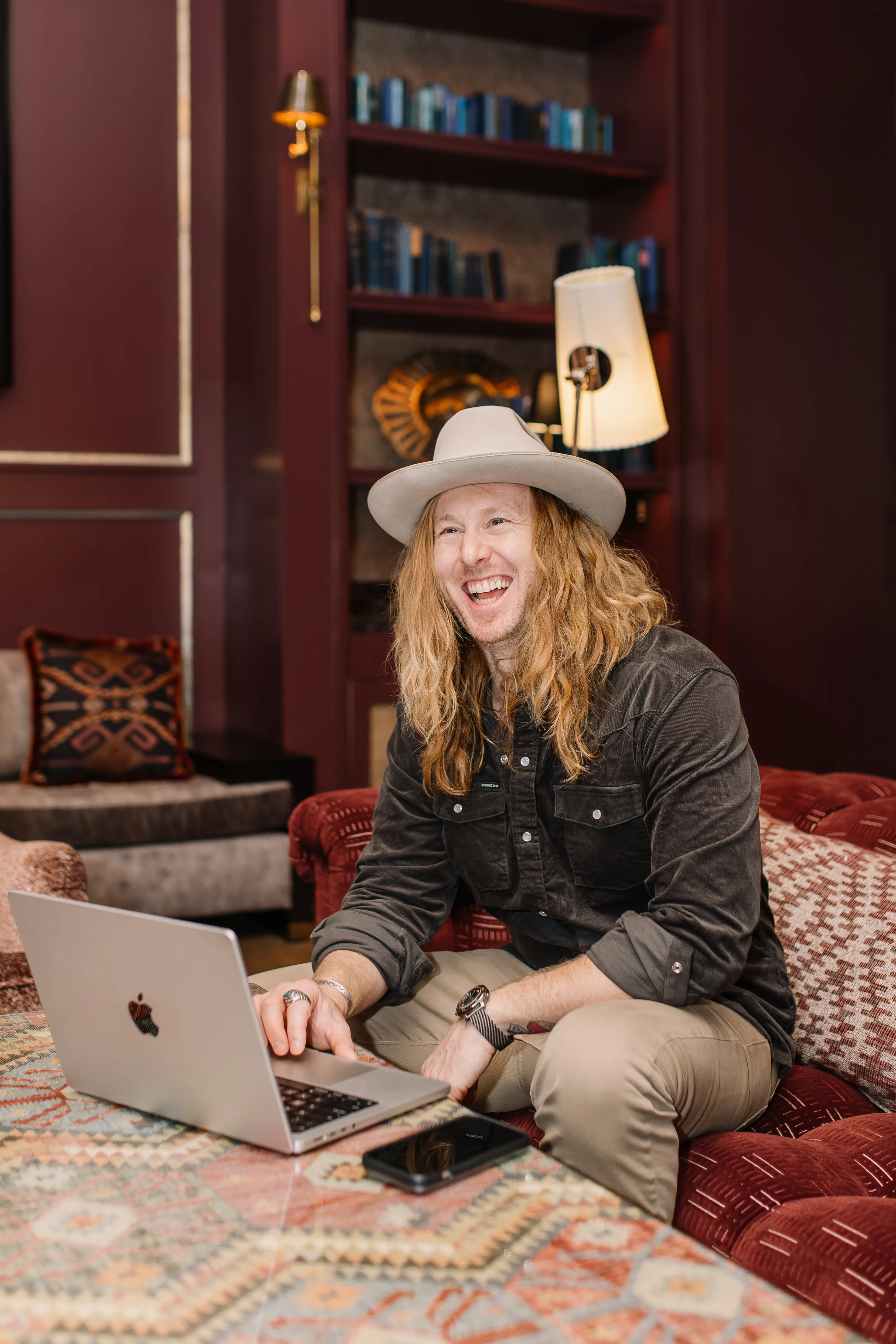 Jamey Ice at Bowie House in Fort Worth, laughing at his laptop.
