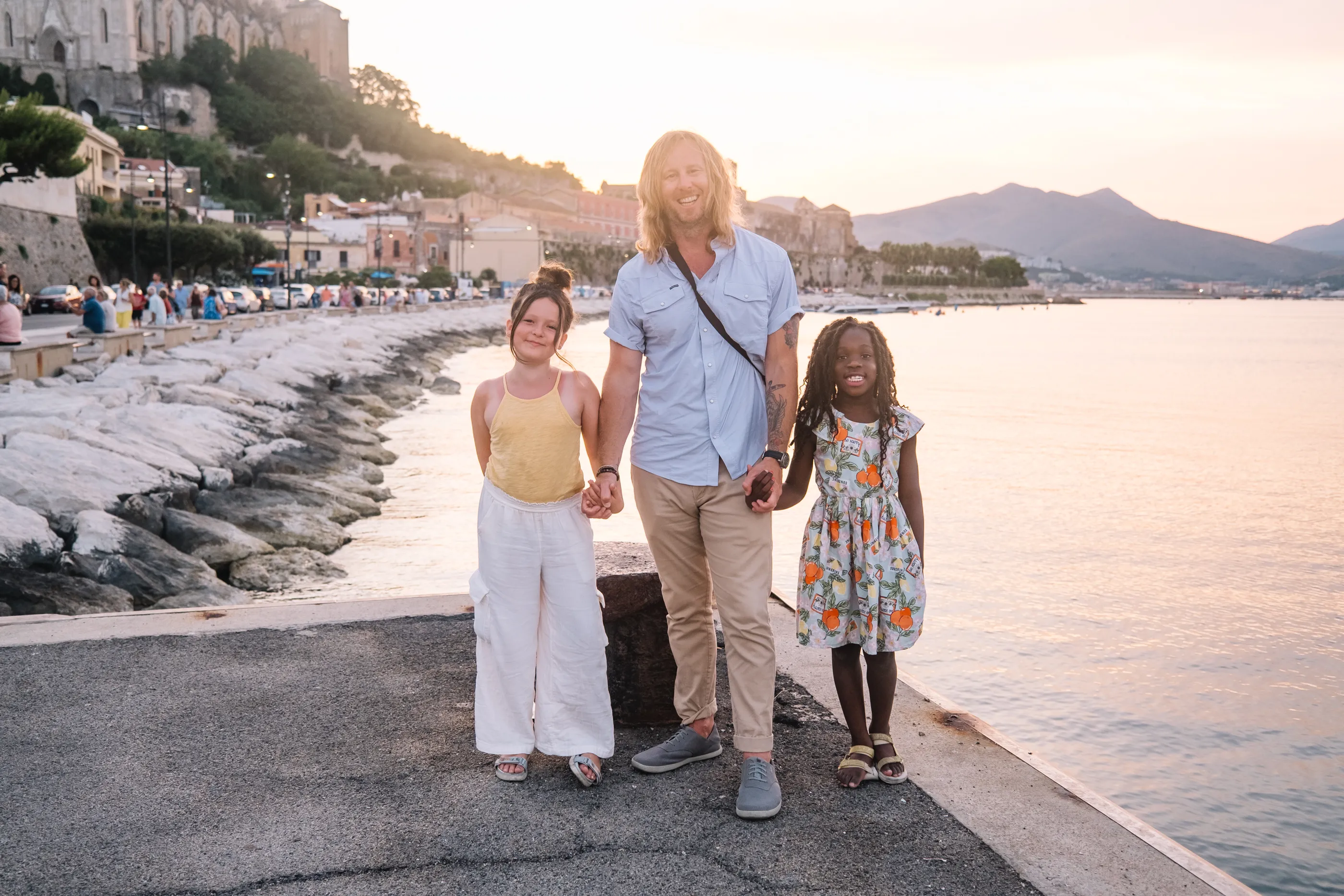 Jamey with his two daughters at sunset on the Italian coast.